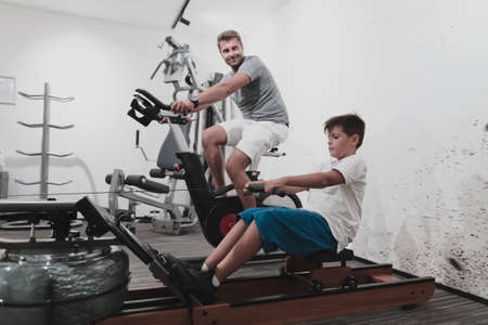 Father and son train together at home gym. The concept of healthy life. Selective focusの写真素材