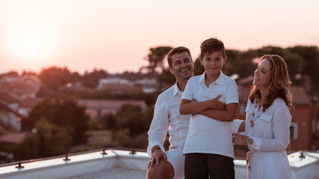 Happy family enjoys and spends time together on the roof of the house. Selective focus
