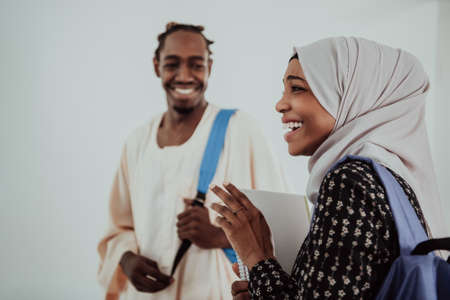 Group of happy african students having conversation and team meeting working together on homework girls wearing traidiional sudan muslim hijab fashionの写真素材