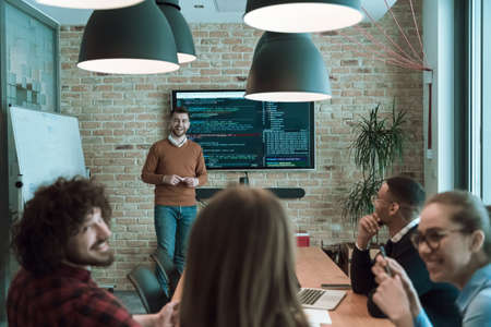 Leader give a business presentation at an office conference meeting, businessman coach mentor explains graph chart on board corporate group workshop training in boardroom. Selective focusの写真素材