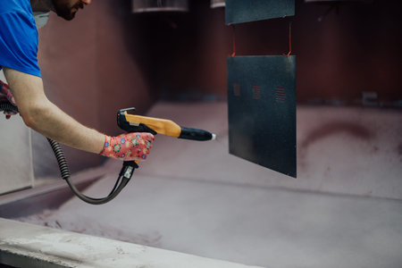 The painter paints the iron element. Industrial painting parts. Metal designs