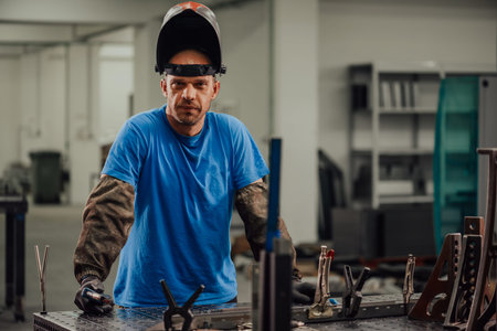 Portrait of Young Professional Heavy Industry Engineer. Worker Wearing Safety Vest and Hardhat...