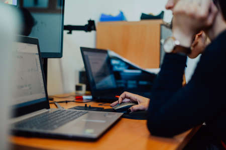 Within the heavy industry, a factory industrial engineer measures with a caliper and on a personal computer Designs a 3D modelの写真素材
