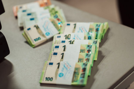 Sorted banknotes placed on the table after it is counted on the electronic money counting machineの写真素材