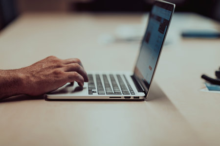 business man hand working on blank screen laptop computer on wooden desk as concept with social...