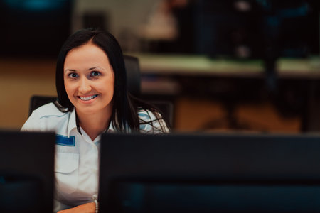 Female security operator working in a data system control room offices Technical Operator Working at...