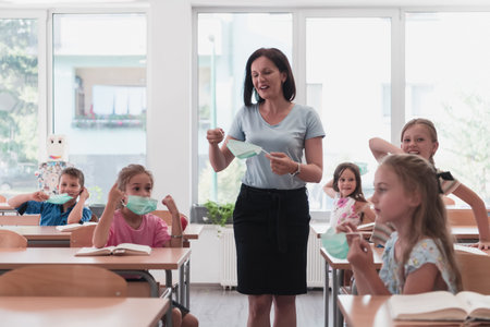 The end of the pandemic. The teacher in the school takes off the protective masks with the students