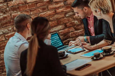 Happy businesspeople smiling cheerfully during a meeting in a coffee shop. Group of successful...