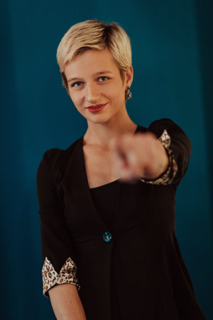 Pretty business woman, successful confidence on modern blue mat background. Selective focus