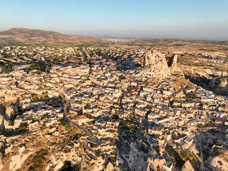 Aerial view of natural rock formations in the sunset, valley with cave houses in Cappadocia, Turkey. Natural landscape city lights at the night.の写真素材