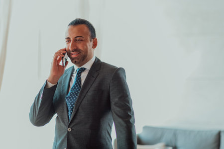 Photo of a businessman in a modern company using a smartphone. Selective focus