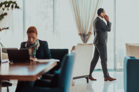 Photo of a businessman in a modern company using a smartphone. Selective focusの写真素材