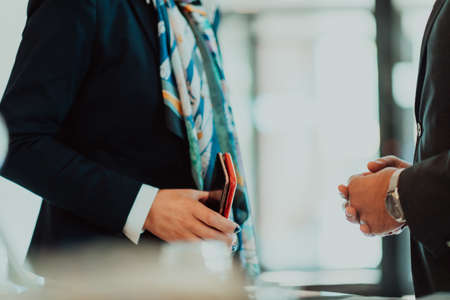 Photo of a businessman and businesswoman discussing business projects in a modern corporation. Selective focusの写真素材