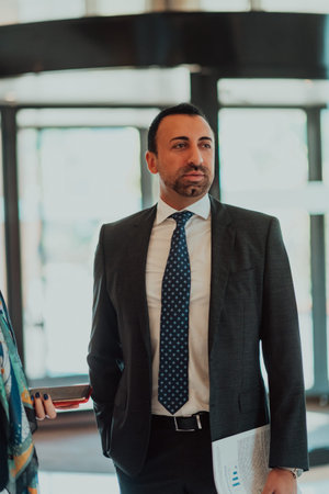Portrait of a businessman in a suit in a modern office building. Selective focus