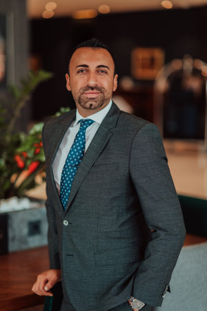 Portrait of a businessman in a suit in a modern office building. Selective focus