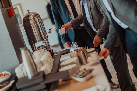 Close-up photo of businessmen serving themselves in a modern hotel during a dinner party. Selective...