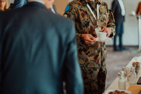 Close-up photo of soldier serving themselves in a modern hotel during a dinner party. Selective focusの写真素材