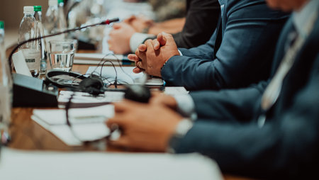 Close-up photo of businessmen serving themselves in a modern hotel during a dinner party. Selective focusの写真素材
