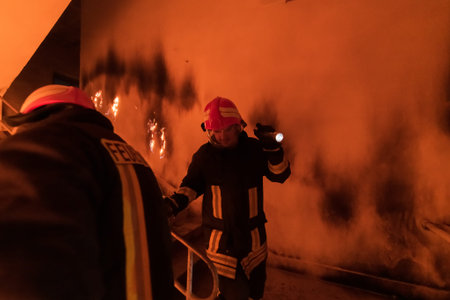 Brave Fireman Descends Stairs of a Burning Building and Holds Saved Girl in His Arms. Open fire and...