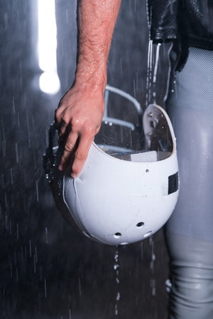 Close up of American Football Athlete Warrior Standing on a Field focus on his Helmet and Ready to...