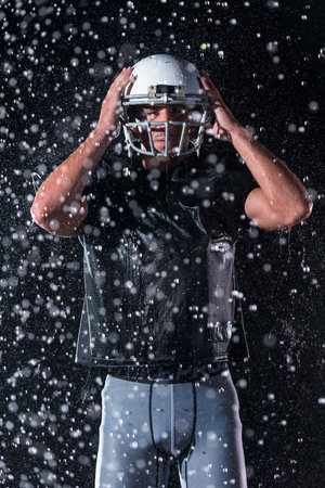 American Football Field: Lonely Athlete Warrior Standing on a Field Holds his Helmet and Ready to...