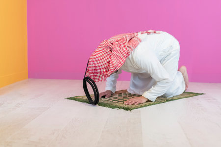 Young muslim man praying salat during Ramadanの写真素材