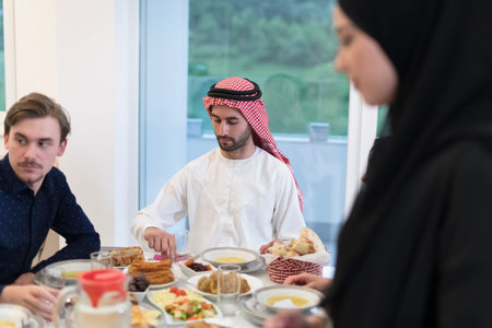 Eid Mubarak Muslim family having Iftar dinner drinking water to break feast. Eating traditional food...