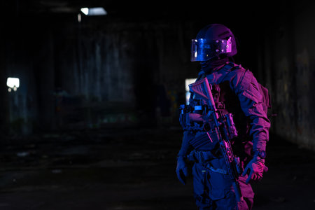 Army soldier in Combat Uniforms with an assault rifle and combat helmet night mission dark background. Blue and purple gel light effect.の写真素材
