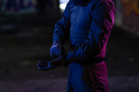 Modern warfare soldier checking navigation, time and other information on a smartwatch. Dark night...