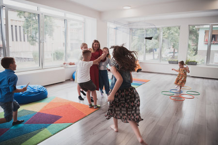 A child hugging a teacher in a modern kindergarten