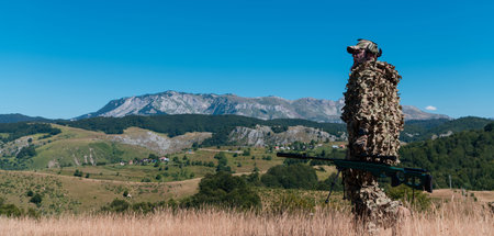army soldier holding a sniper rifle with scope and walking in the forest. war, army, technology and people concept.の写真素材