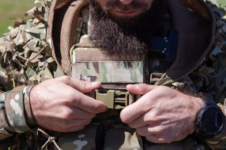 special operations soldiers team preparing tactical and communication gear for action battle. Long...
