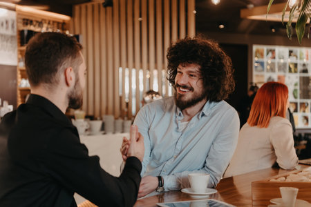 A group of friends hanging out in a cafe, and among them is a tablet.の写真素材