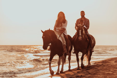The family spends time with their children while riding horses together on a sandy beach. Selective focusの写真素材