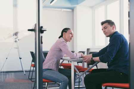 businesspeople, rivalry and people concept - businesswoman and businessman arm wrestling during...