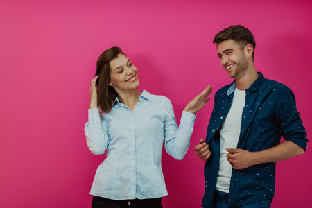 A happy young couple sitting on the floor in the house and making selfieの写真素材