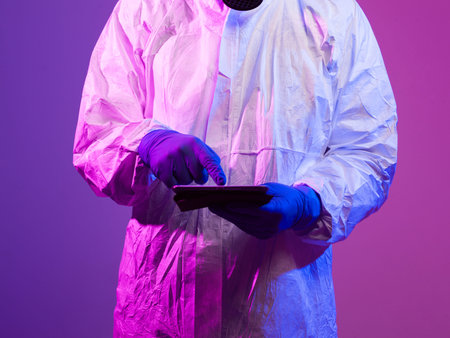 Photo of a doctor in the virus ward using a tablet for modern diagnosis
