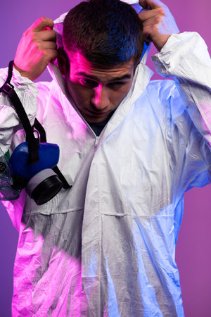 Doctor scientist wearing protective biological suit and mask due to global healthcare epidemic...