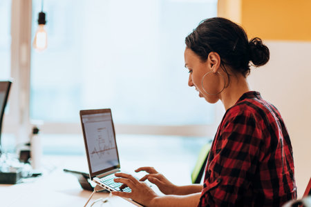 A young woman using a laptop to present her business with online clients