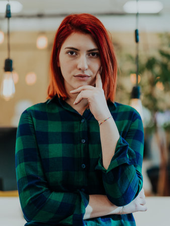 Headshot portrait of a modern woman in the office at night by the window
