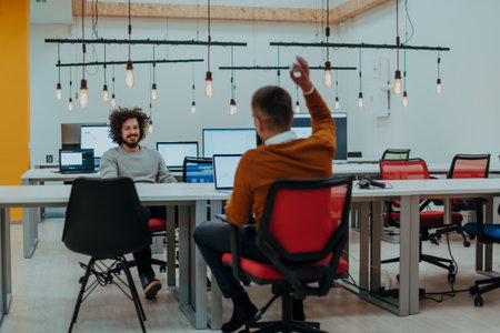 Two men having fun on a break from work in a modern officeの写真素材