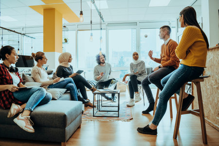 Young designer giving some new ideas about project to his partners in conference room. Business people discussing over new business project in office.の写真素材