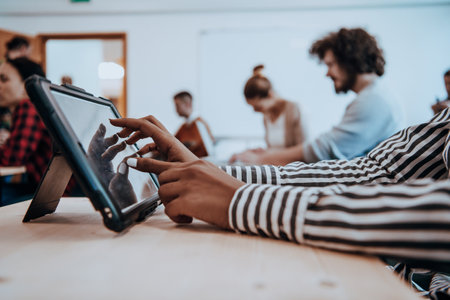 Young African American businesswoman talking on a smartphone in a modern startup office. Marketing concept. Multi-ethnic society.の写真素材