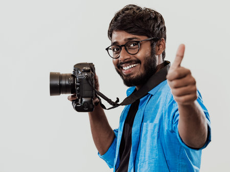 Professional photographer having DSLR camera taking picture.Indian man photography enthusiast taking...