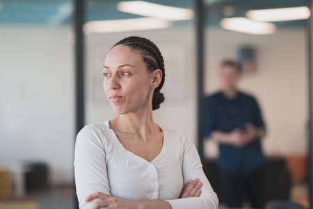 Portrait of young smiling business woman in creative open space coworking startup office. Successful...