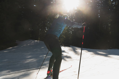 Nordic skiing or Cross-country skiing classic technique practiced by man in a beautiful panoramic trail at morning.の写真素材