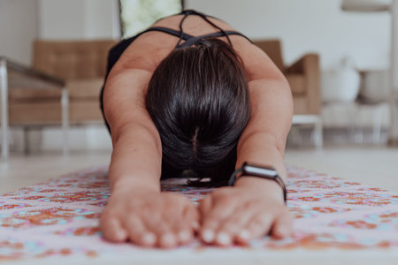 Young Beautiful Female Exercising, Stretching and Practising Yoga with Trainer via Video Call Conference in Bright Sunny House. Healthy Lifestyle, Wellbeing and Mindfulness Concept.の写真素材