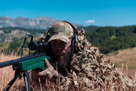 Army soldier holding sniper rifle with scope and aiming in forest. War, army, technology and people conceptの写真素材