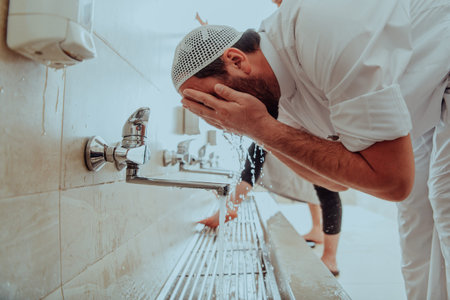 A Muslim performing ablution. Ritual religious cleansing of Muslims before performing prayer. The...