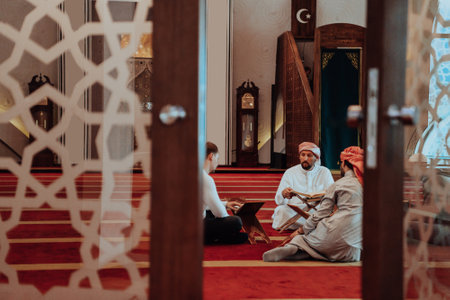 A group of Muslims reading the holy book of the Quran in a modern mosque during the Muslim holiday of Ramadanの写真素材